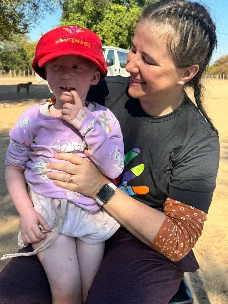 Luísa Marteleto holding a child in her arms