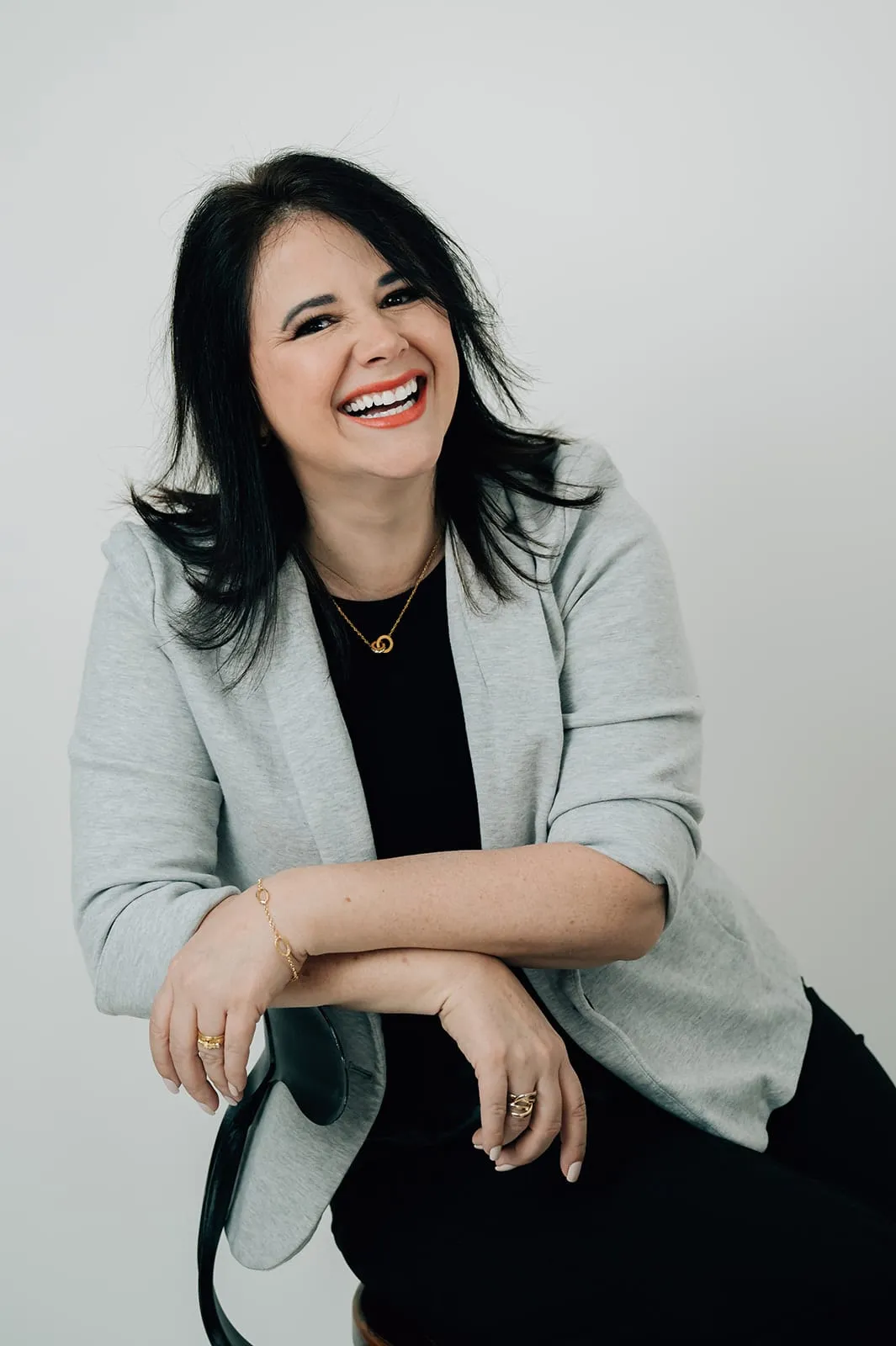 Studio portrait of Luísa Marteleto in a gray blazer